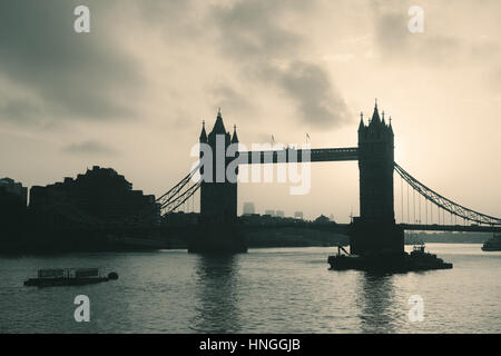 Tower Bridge silhouette over Thames River in London. Stock Photo