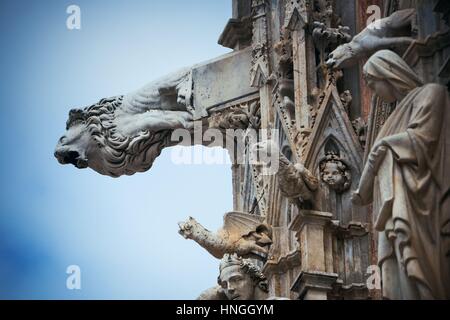 Siena Cathedral gargoyle closeup as the famous landmark in medieval town in Italy. Stock Photo