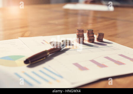 coin, pen and business document on wooden table, selective focus and vintage tone Stock Photo