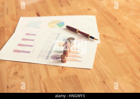 coin, pen and business document on wooden table, selective focus and vintage tone Stock Photo