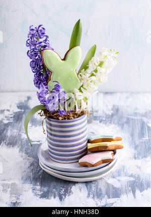 Easter composition with beautiful spring flowers and decorated cookies Stock Photo