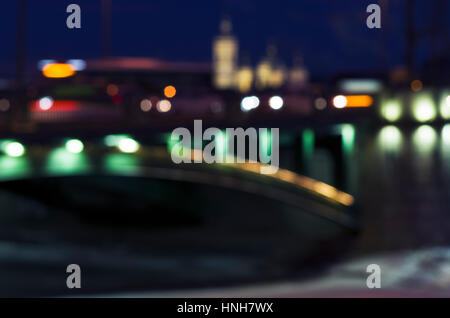 Unfocused photo of the cityscape with silhouettes of buildings, bridge, embankment and bus, Saint-Petersburg, Russia Stock Photo