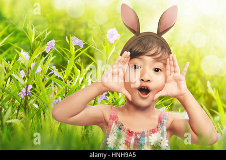 Happy girl expression with bunny ears in the garden Stock Photo