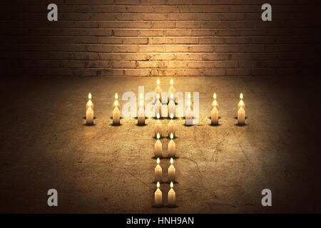 Burning candles in the form of a cross on the dark room Stock Photo