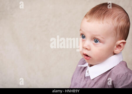 Blue eyed baby boy looking into copy space Stock Photo