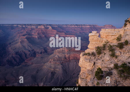 Scenic aerial view of famous Grand Canyon, often considered one of the Seven Natural Wonders of the World, in beautiful post sunset twilight at dusk Stock Photo