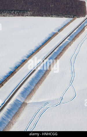 aerial view over snowy field and road Stock Photo - Alamy
