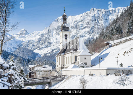 Classic view of famous Parish Church of St. Sebastian embedded in scenic winter wonderland landscape in the Alps, village of Ramsau, Bavaria, Germany Stock Photo