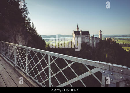 Beautiful view of world-famous Neuschwanstein Castle, the 19th century Romanesque Revival palace built for King Ludwig II, in evening light at sunset  Stock Photo