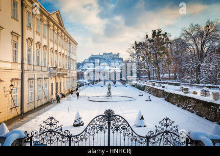 Classic view of famous Mirabell Gardens with historic Hohensalzburg Fortress in the background at sunset in winter, Salzburg, Salzburg Land, Austria Stock Photo