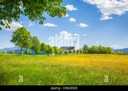 Classic view of famous Wilparting Pilgrimage Church with green meadows and trees on a beautiful sunny day in springtime, Irschenberg, Bavaria, Germany Stock Photo