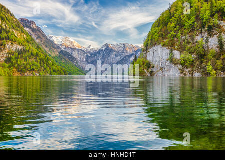 Beautiful view of famous Lake Konigssee with idyllic mountain scenery and famous Sankt Bartholomae pilgrimage church in the background in springtime,  Stock Photo