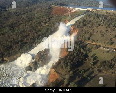 Oroville, USA. 12th Feb, 2017. Aerial photo of the massive amounts of water overwhelming the Oroville Dam spillway eroding the hillside February 12, 2017 in Oroville, California. A mandatory evacuation order was issued for 200,000 residents surrounding the nation's tallest dam. (William Croyle/California DWR via Planetpix) Credit: Planetpix/Alamy Live News Stock Photo