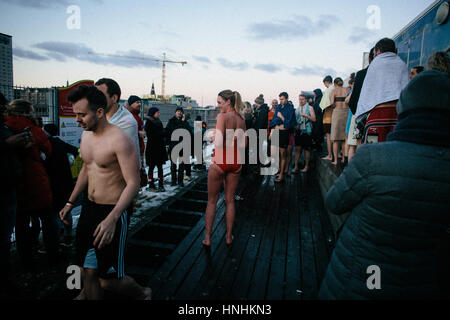 Denmark, Copenhagen, February 12th 2017. Winter swimming daredevils jump the ice waters of Copenhagen’s harbour pool as part of the event “Ilddåb” during the Danish art and music festival Frost Festival 2017 in Copenhagen. In the darkness the winter swimmers were encouraged to jump the coul water by fire canons illumination he sky and interactive lightning in- and outside the harbour pool. Credit: Gonzales Photo/Alamy Live News Stock Photo
