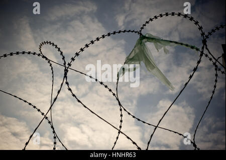 Gevgelija, Macedonia. 13th Feb, 2017. Remains of a plastic bag at the fence of the Macedonian border with Greece in Gevgelija. As borders remind closed along the refugee route near one hundred migrants of Iraqi, Iranian and Syrian nationalities are staying, most of them since one year ago, at the Temporary Transit Center of Gevgelija. Credit: Jordi Boixareu/Alamy Live News Stock Photo