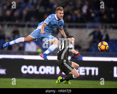 Rome, Italy. 13th Feb, 2017. Lazio's Ciro Immobile vies with AC Milan's Ignazio Abate during the Serie A soccer match between AC Milan and Lazio in Rome, Italy, Feb. 13, 2017. The match ended with a 1-1 draw. Credit: Alberto Lingria/Xinhua/Alamy Live News Stock Photo