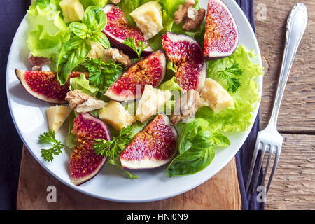 Fig fruits, cheese and walnuts salad on plate close up - homemade healthy vegetarian or diet salad Stock Photo