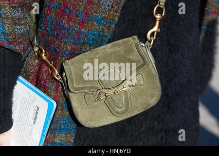 Woman with olive green suede Gucci bag before Dirk Bikkembergs fashion show, Milan Fashion Week street style on January 15, 2017 Stock Photo