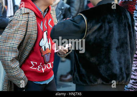 Men with black fur and red sweater before MSGM fashion show, Milan Fashion Week street style on January 16, 2017 in Milan. Stock Photo