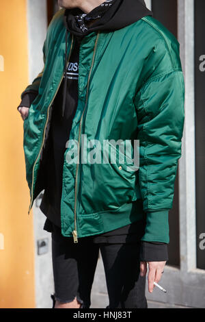 Man with green bomber jacket before Giorgio Armani fashion show, Milan Fashion Week street style on January 17, 2017 in Milan. Stock Photo