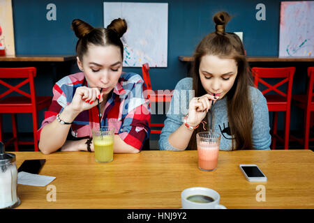 Young girls having fun in a cafe bar. Stock Photo