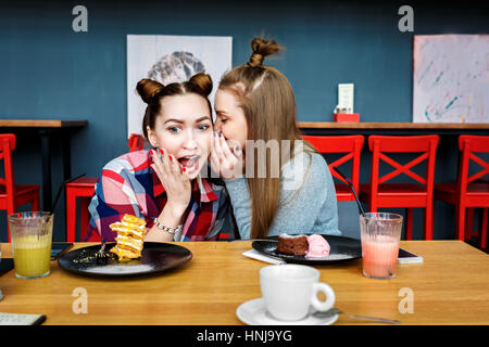 happy girl friends have cup of coffee in modern city restaurant. Stock Photo