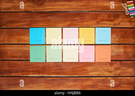 colorful photo frames on wooden table view from top Stock Photo