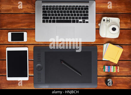 mockup of hipster gadgets on wooden table view from above. Stock Photo