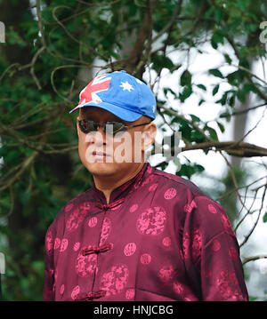 Asian man wearing a cap with the Australian flag on Australia Day 2017 , Berrima, New South Wales, Australia Stock Photo