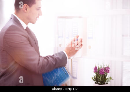 File folders, standing on shelves in background Stock Photo