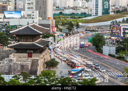 SEOUL, SOUTH KOREA - SEPTEMBER 8, 2015: Cars rush around Heunginjimun gate (or Dongdaemun gate) which is part of the fortress wall in Seoul in South K Stock Photo