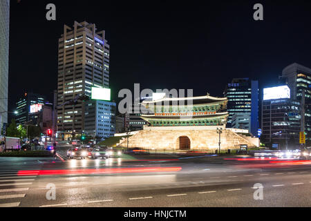 SEOUL, SOUTH KOREA - SEPTEMBER 8, 2015: Traffic, captured with long exposure, rushes along the Sungnyemun Gate which is a remain of the old Seoul fort Stock Photo