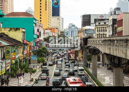 KUALA LUMPUR, MALAYSIA - NOVEMBER 4, 2014: A monorail car travel on its elevated track above heavy traffic in the street of Kuala Lumpur, Malaysia cap Stock Photo