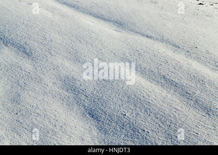 covered with white snow drifts surface. Photo closeup. On snow formed irregularities. Photo close-up, small depth of field Stock Photo