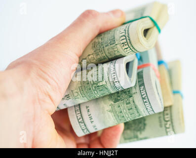 Hand holds a lot of packs with dollar bills Stock Photo