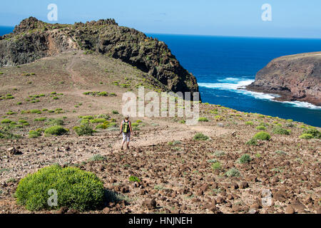 tourist walking at path at coastal path at el juncal, gran canaria, spain Stock Photo