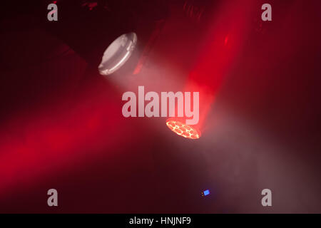 Stage spot lights with red beams in smoke, stage illumination equipment Stock Photo