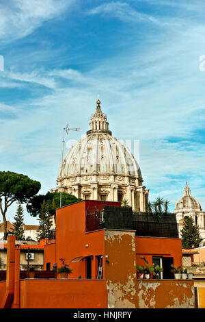 Unusual view of Saint Peter cathedral’s dome seen from the back, dominating the adjacent buildings. Cupola Basilica San Pietro. Rome, Italy, Europe EU. Stock Photo