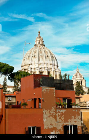 Saint Peter cathedral’s dome seen from the back, dominating the adjacent buildings. Cupola Basilica San Pietro. Rome, Italy, Europe, EU. Copy space. Stock Photo