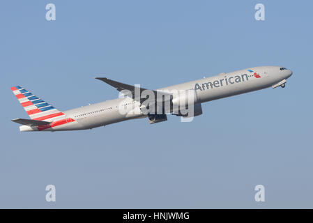 American Airlines Boeing 777-323ER N724AN taking off from London Heathrow Airport in blue sky Stock Photo