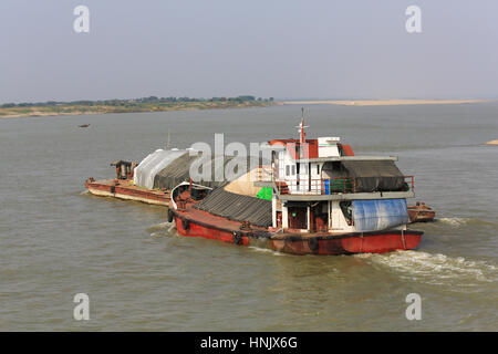 Tug and barge traffic on the Irrawaddy River north of Bagan in Myanmar (Burma). Stock Photo