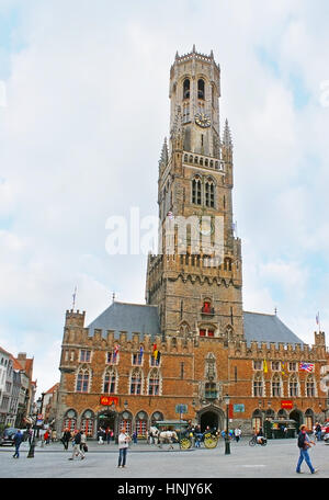 BRUGES, BELGIUM - MAY 26, 2011: The Belfry of Bruges (Halletoren) located at the Markt Square and is one of the city's symbols, on May 26 in Bruges. Stock Photo