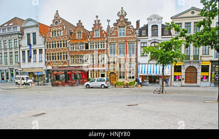 GHENT, BELGIUM - MAY 26, 2011: The old buildings with crow-stepped gables at Vrijdagmarkt Square, the city's marketplace, with cafes and stores on the Stock Photo
