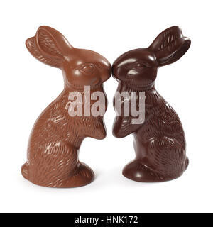 Photo of two chocolate Easter bunnies kissing, one milk chocolate and one dark chocolate. Clipping Path included. Stock Photo