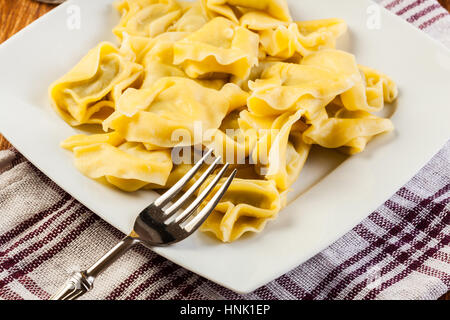 Tortellini shells filled with chesse Stock Photo