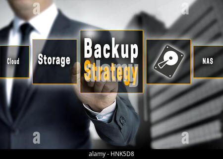 Backup Strategy touchscreen is operated by a businessman. Stock Photo