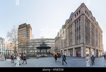 DUESSELDORF, GERMANY - FEBRUARY 13, 2017: Unidentified pedestrants cross the Heinrich Heine Platz infront of the Carschhaus Stock Photo