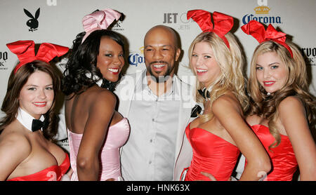 Rapper Common, center, poses with Playboy bunnies at the Playboy Super