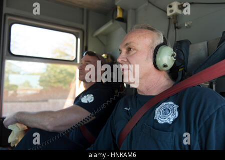 Las Vegas Fire & Rescue Fire Station 41 firefighters Ted Ramey, right, and Tony DiDona sit in a fire truck cab en route to an emergency call. Stock Photo