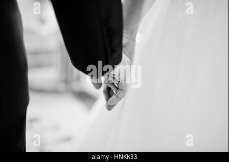 Close up hand in hand of wedding couple. Black and white photo Stock Photo